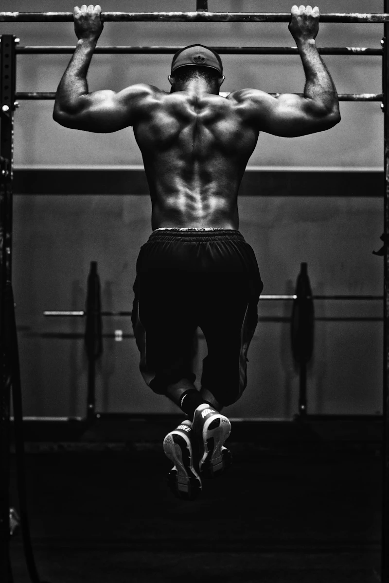 Determined athlete mid-session, captured in dramatic gym lighting