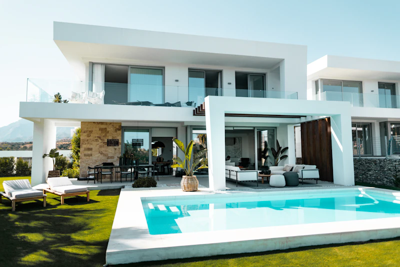 Luxury single-level home exterior illuminated at dusk